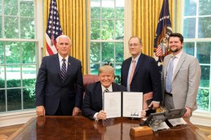 President Trump, Vice President Pence, and National Space Council staff in the Oval Office with the signed Space Policy Directive-2